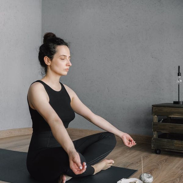 Person meditating in a calm environment, symbolizing mental peace and balance.